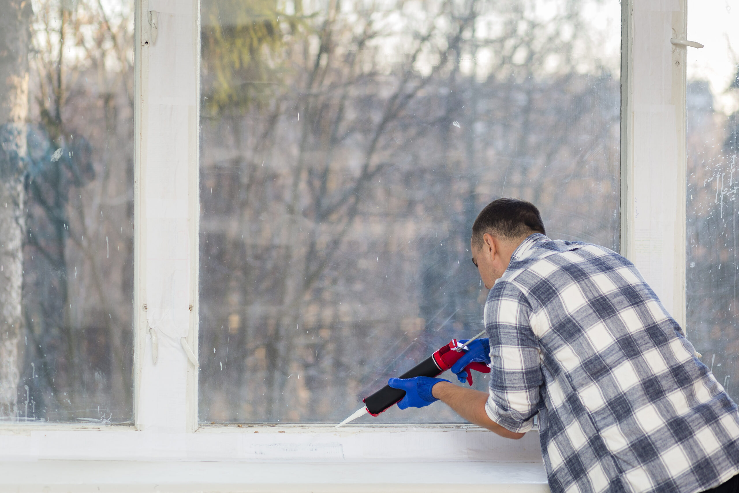 man-putting-silicone-wall